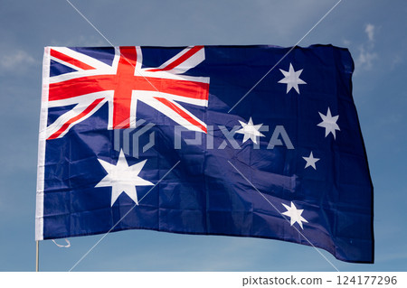 Large flag of Australia waving against sky 124177296