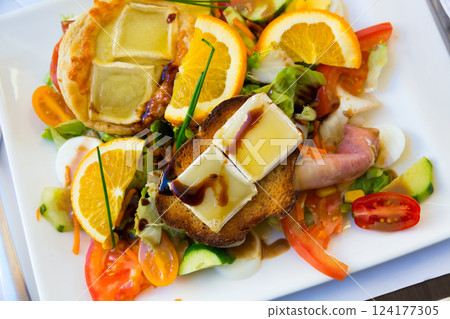 Salad with goat cheese, greens, vegetables Salad with goat cheese, greens, vegetables 124177305