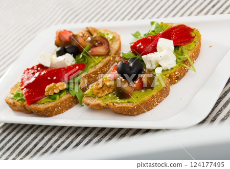 Sandwiches with guacamole, tomatoes, pepper and feta cheese Sandwiches with guacamole, tomatoes, pepper and feta cheese 124177495