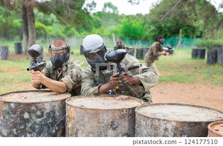 Portrait of two confident male paintball players in masks 124177510