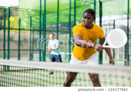 African american man playing padel tennis 124177862