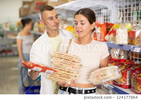 Couple man and woman choosing noodles Couple man and woman choosing noodles 124177864