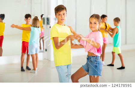 Active young children enjoying of partner dance in class Active young children enjoying of partner dance in class 124178591