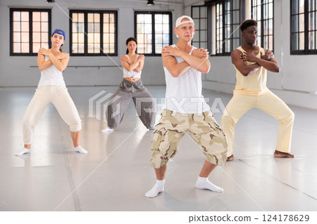 Team of dancers performing hip-hop dance Team of dancers performing hip-hop dance 124178629