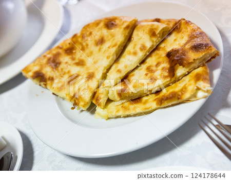 Traditional dish of Georgian cuisine is Khachapuri flatbread with cheese Traditional dish of Georgian cuisine is Khachapuri flatbread with cheese 124178644