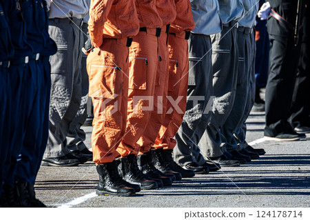 Firefighters stand perfectly still in formation during the New Year's parade ceremony. 124178714