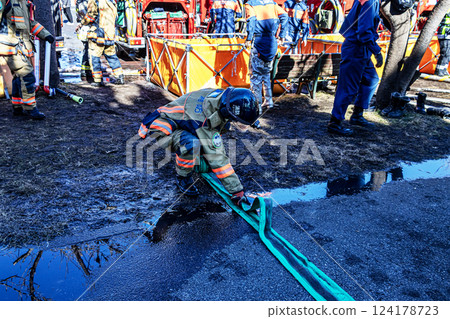 Firefighters demonstrate firefighting techniques at the New Year's parade and put away fire hoses 124178723