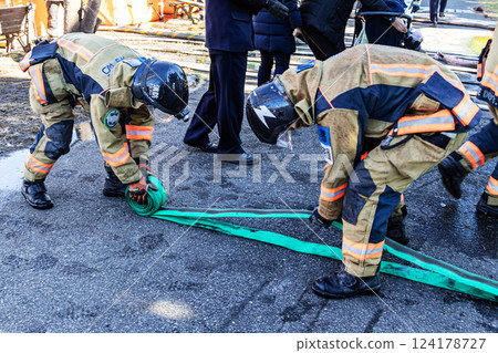 Firefighters demonstrate firefighting techniques at the New Year's parade and put away fire hoses 124178727
