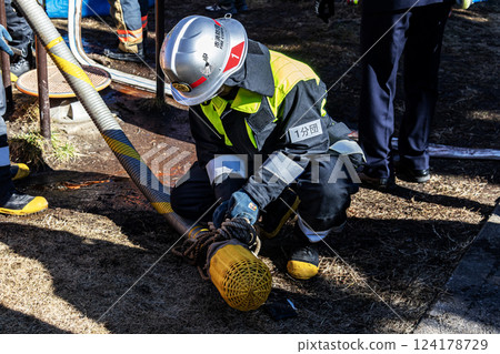 Firefighters demonstrate firefighting techniques at the New Year's parade and put away fire hoses 124178729