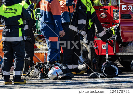 Firefighters prepare to go next to a fire engine to demonstrate firefighting at the New Year's parade 124178731