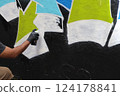 Spray painting street graffiti on a wall Spray painting street graffiti on a wall 124178841