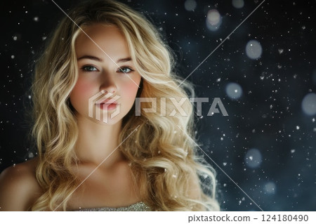 Beautiful blonde woman with long, curly hair in a nightdress standing under a snowfall. Beautiful blonde woman with long, curly hair in a nightdress standing under a snowfall. 124180490