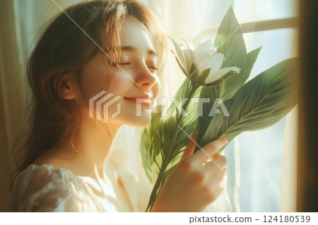 A beautiful woman is holding fresh green herbs in her hands. A beautiful woman is holding fresh green herbs in her hands. 124180539
