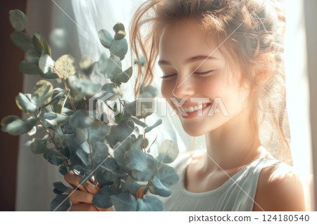 A beautiful woman is holding fresh green herbs in her hands. A beautiful woman is holding fresh green herbs in her hands. 124180540