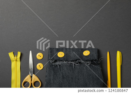 Denim handmade bag, tools and materials on gray background, space for text Denim handmade bag, tools and materials on gray background, space for text 124180847