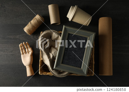 Wooden hand, paper cup and materials for upcycling on wooden background, top view 124180858