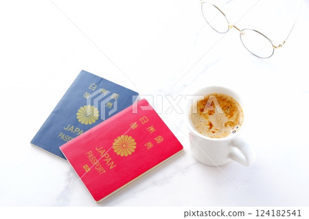 Image of preparing passports (red for 10 years and navy blue for 5 years) and planning an overseas trip while drinking coffee 124182541