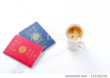 Image of preparing passports (red for 10 years and navy blue for 5 years) and planning an overseas trip while drinking coffee 124182542