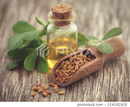 Fenugreek seeds with oil in bottle 124182928