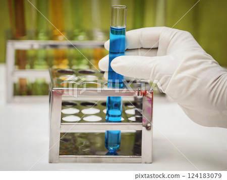 Hand holding a test tube Hand holding a test tube 124183079