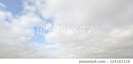 Blue sky with scattered white clouds on day showcasing calm natural landscape. nature background, scenic projects relaxation visuals promotions outdoor 124183129