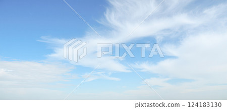Blue sky background with soft white clouds, sunny weather, natural daylight, peaceful atmosphere, nature themes, serene and calm outdoor environment 124183130