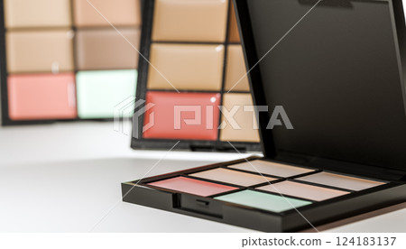 Makeup concealer palette with various colors, professional cosmetic kit, skin tone correction, beauty product, foundation set, open compact case, close-up 124183137
