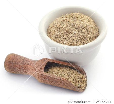 Liquorice stick and ground in a small bowl 124183745