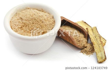 Liquorice stick and ground in a small bowl Liquorice stick and ground in a small bowl 124183749