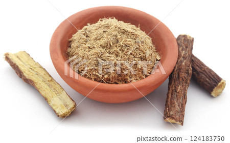 Liquorice stick and ground in a small bowl Liquorice stick and ground in a small bowl 124183750