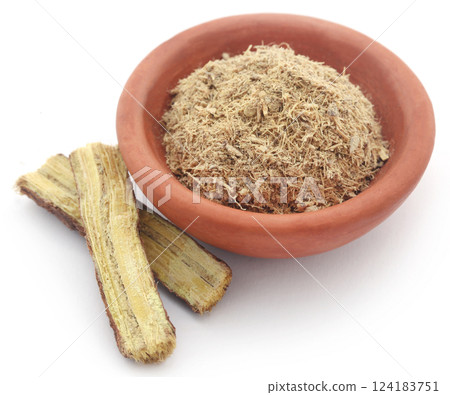 Liquorice stick and ground in a small bowl Liquorice stick and ground in a small bowl 124183751