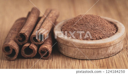 Fresh aromatic cinnamon with ground spice 124184250