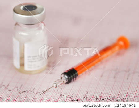 Syringe vial on electrocardiograph Syringe vial on electrocardiograph 124184641