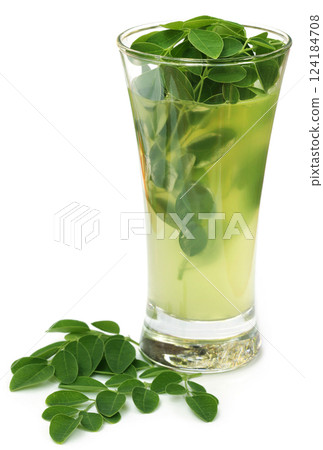 Moringa leaves with extract in a glass Moringa leaves with extract in a glass 124184708