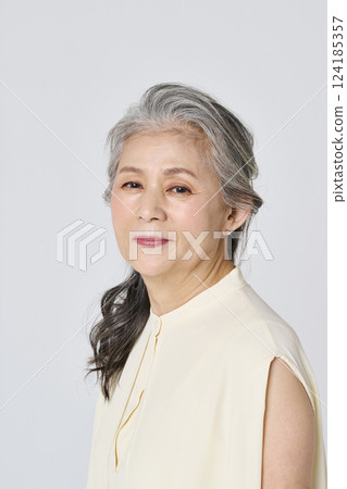 Portrait of a senior woman smiling elegantly Portrait of a senior woman smiling elegantly 124185357