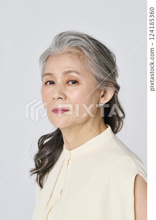 Portrait of a senior woman smiling elegantly 124185360