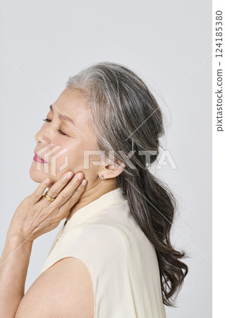 Portrait of a senior woman smiling elegantly Portrait of a senior woman smiling elegantly 124185380