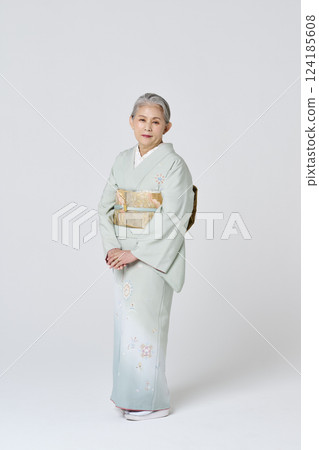 Smiling senior woman in a pale green kimono Smiling senior woman in a pale green kimono 124185608