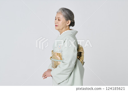 Profile of a senior woman wearing a purple kimono 124185621