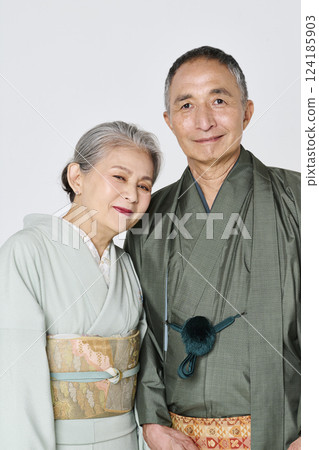 Senior couple wearing kimonos smiling happily Senior couple wearing kimonos smiling happily 124185903