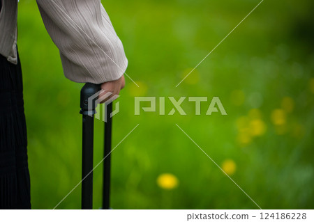 Hand holding a trolley bag handle Hand holding a trolley bag handle 124186228