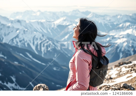 A woman enjoying the exhilaration of reaching the summit 124186606