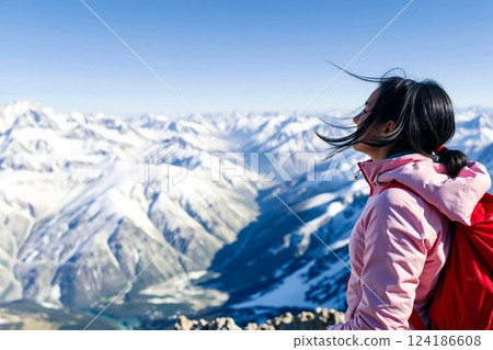 A woman enjoying the exhilaration of reaching the summit 124186608