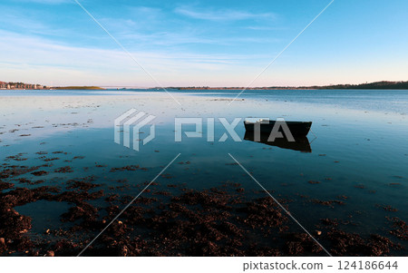 Lonely boat in Roskilde fjord of Denmark Lonely boat in Roskilde fjord of Denmark 124186644