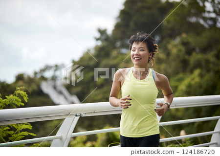 young asian woman running jogging outdoors 124186720