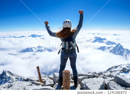 A woman who reaches the summit and gives a fist pump 124186972