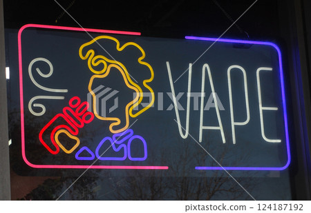 Neon Sign in Window of Vape Shop 124187192