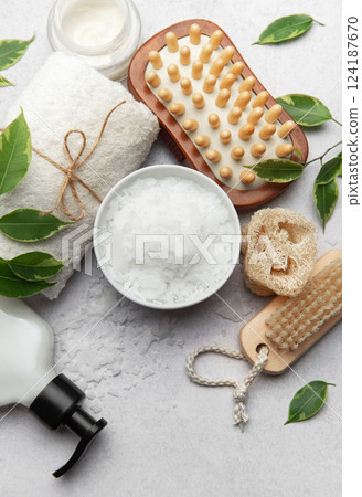 Preparing relaxing wellness magnesium bath with soap, towel and sponge 124187670