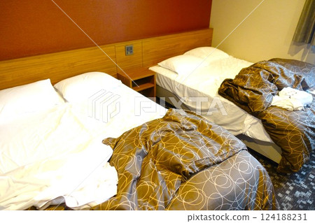 Messy hotel bed at checkout 124188231