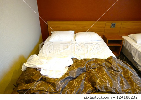 Messy hotel bed at checkout 124188232